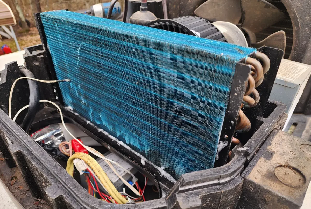 RV AC technician repairing air conditioning unit in Jensen Beach